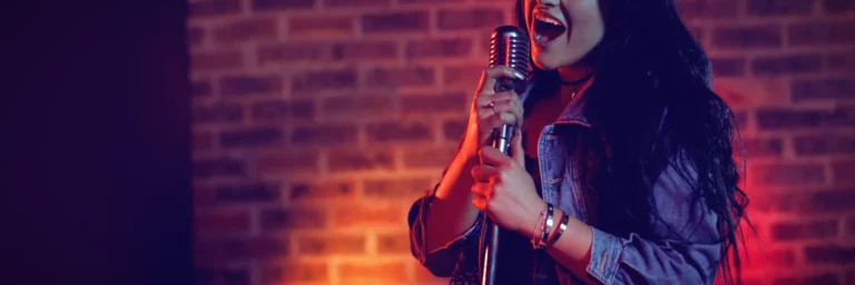cheerful-female-singer-with-long-hair-singing-illuminated-nightclub